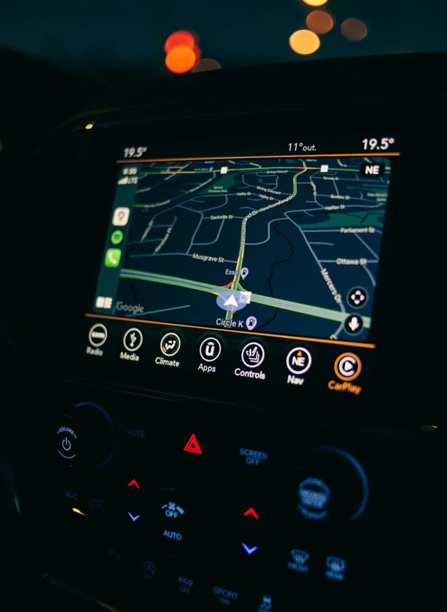 a car dashboard with a gps device in the middle of it